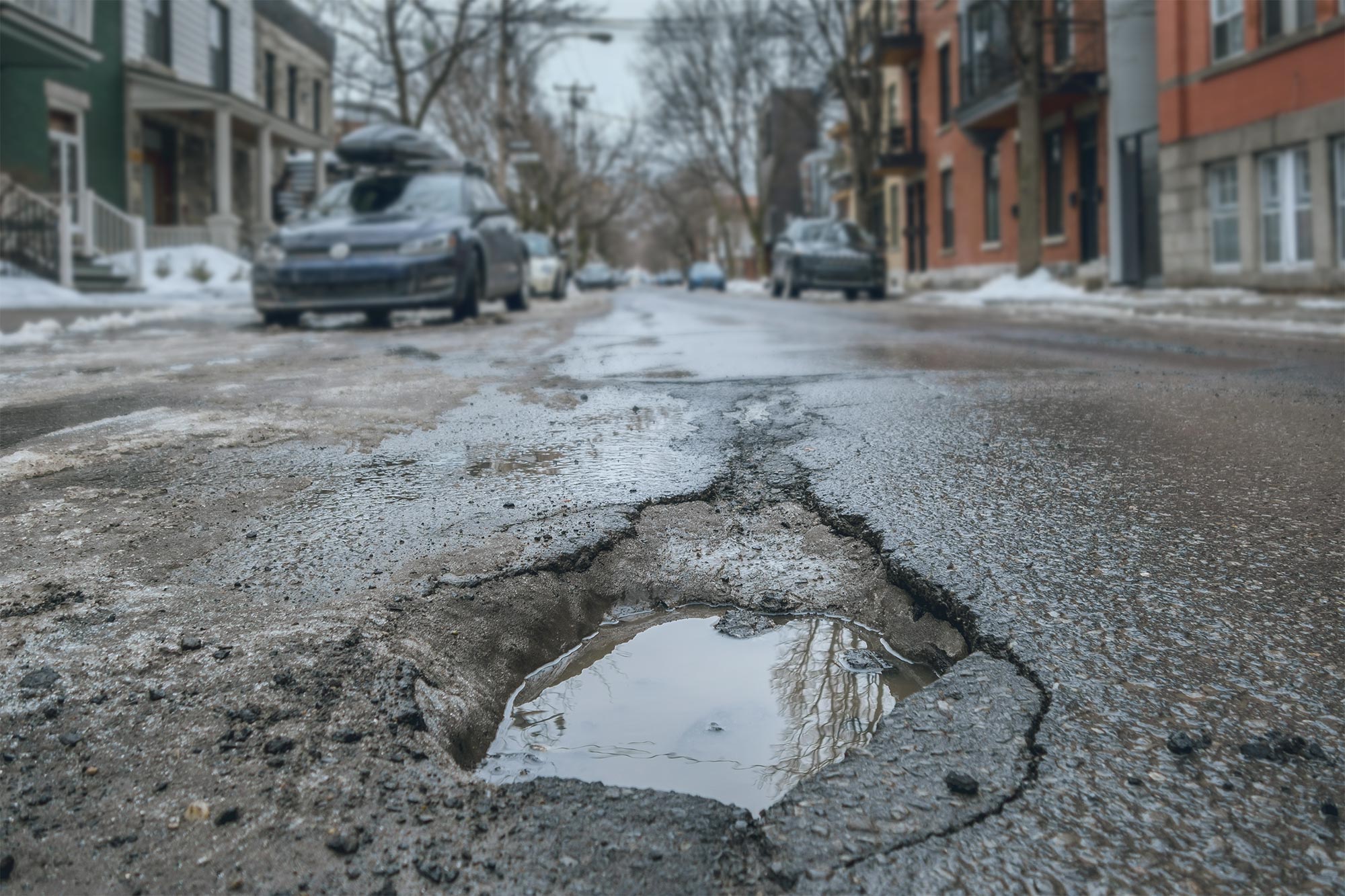 Close up of large pothole on a city street.