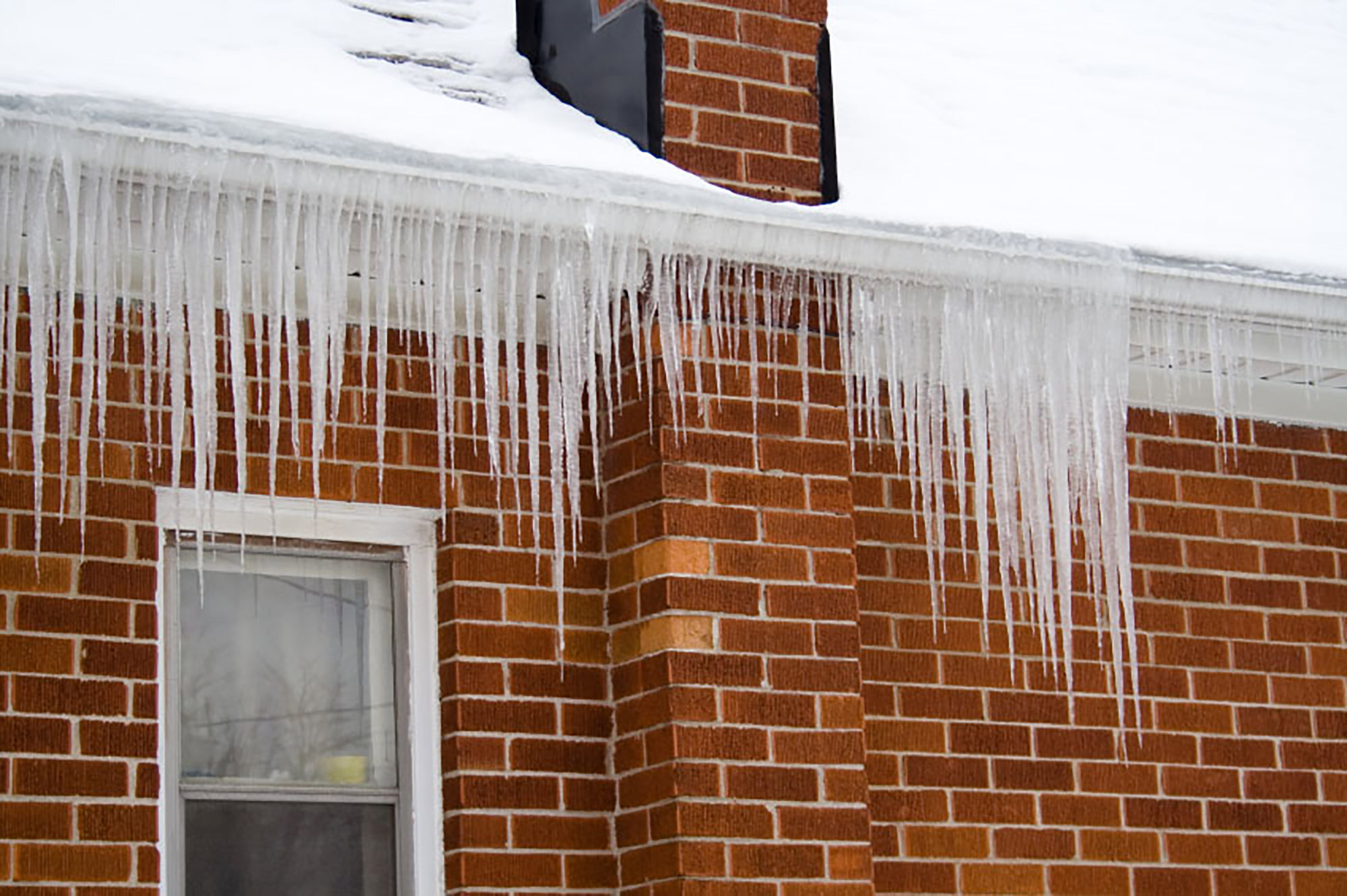 Close-up of icicles on gutters of house.