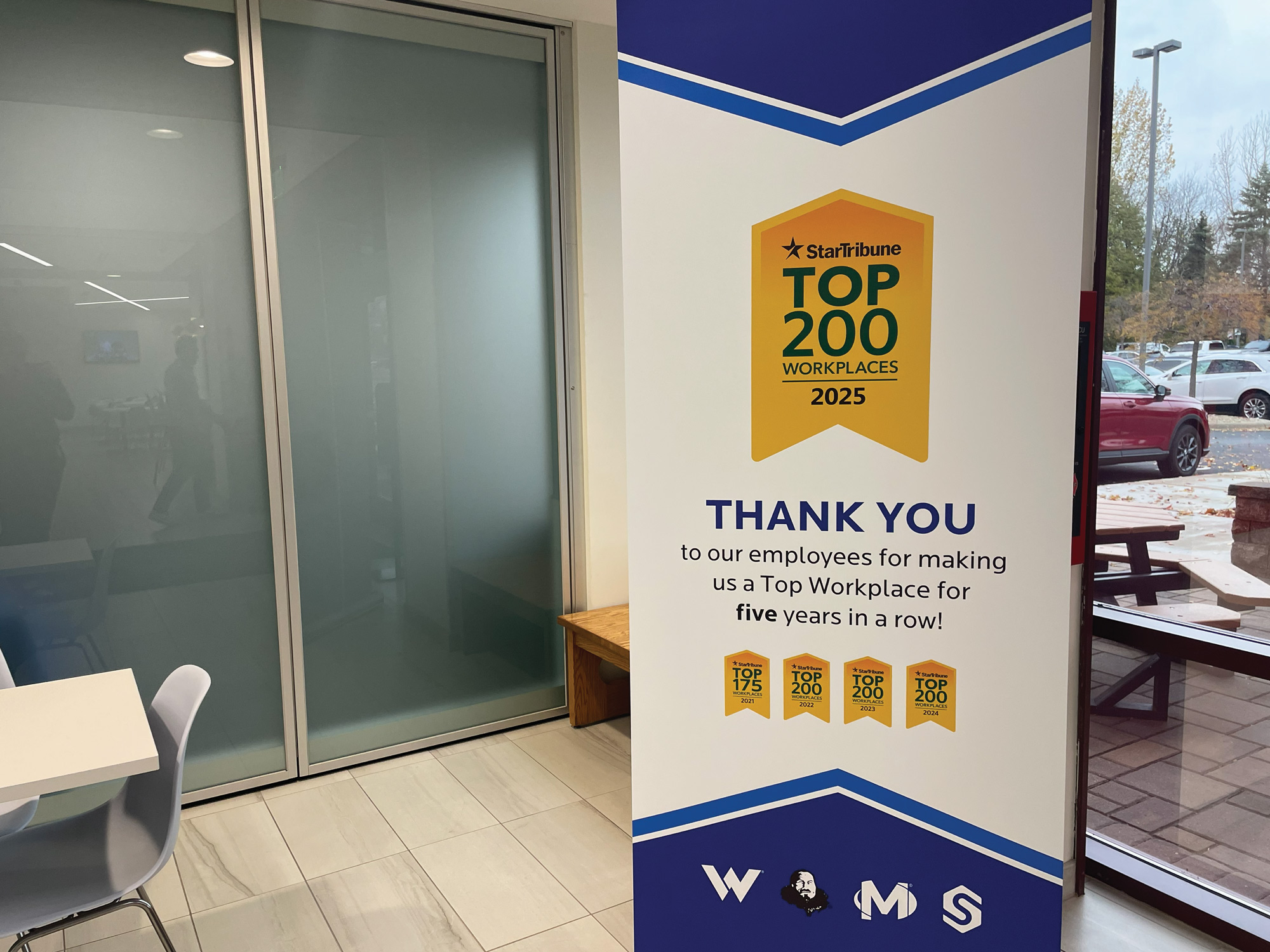 A Top Workplace pull-up banner in the lobby of the Western National Twin Cities office.
