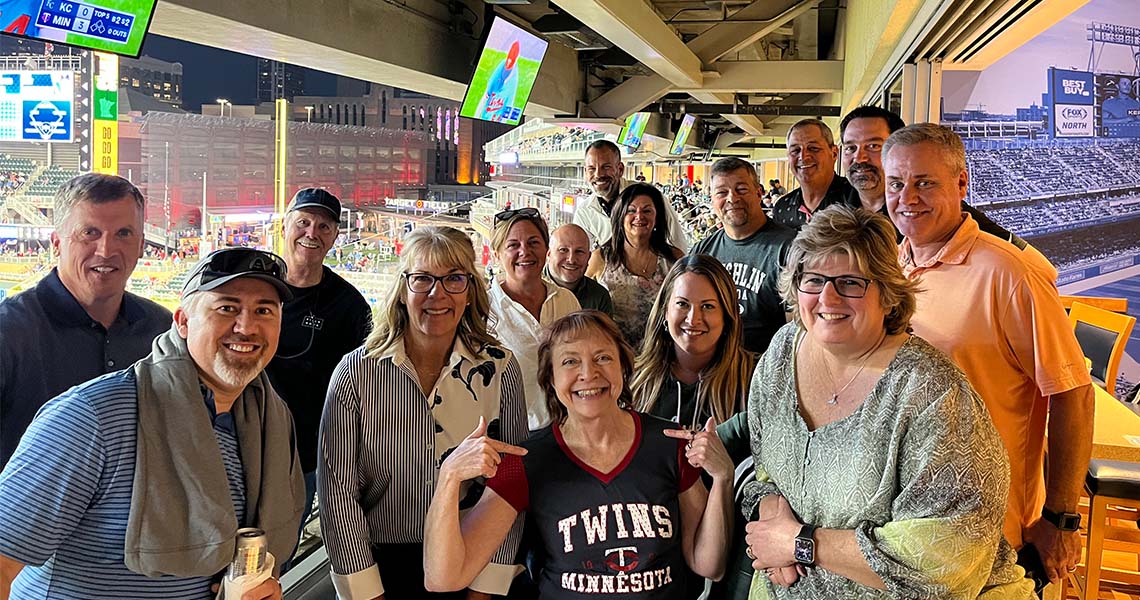 Large group of Western National employees posing for a photo together while attending a Minnesota Twins baseball game.