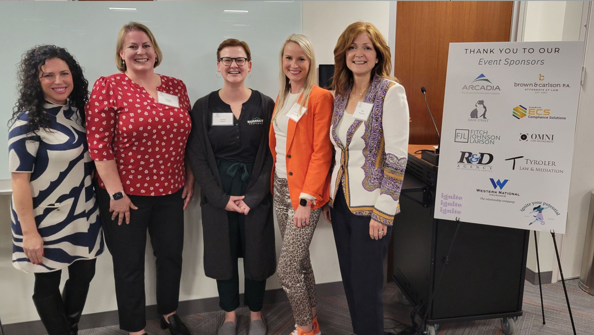 A group of women at the Alliance of Women in Workers' Compensation event.