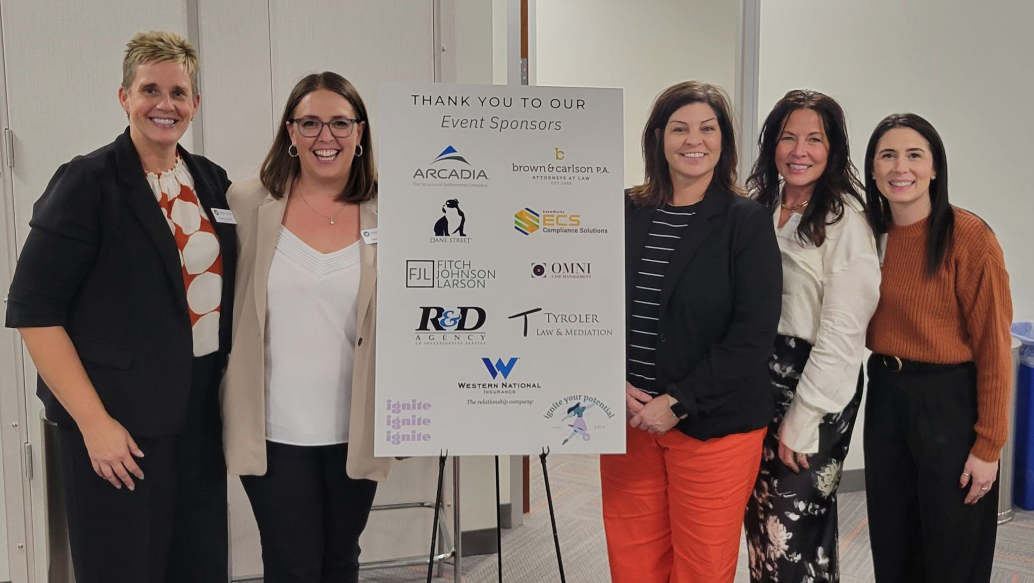 A group of women at the Alliance of Women in Workers' Compensation event.