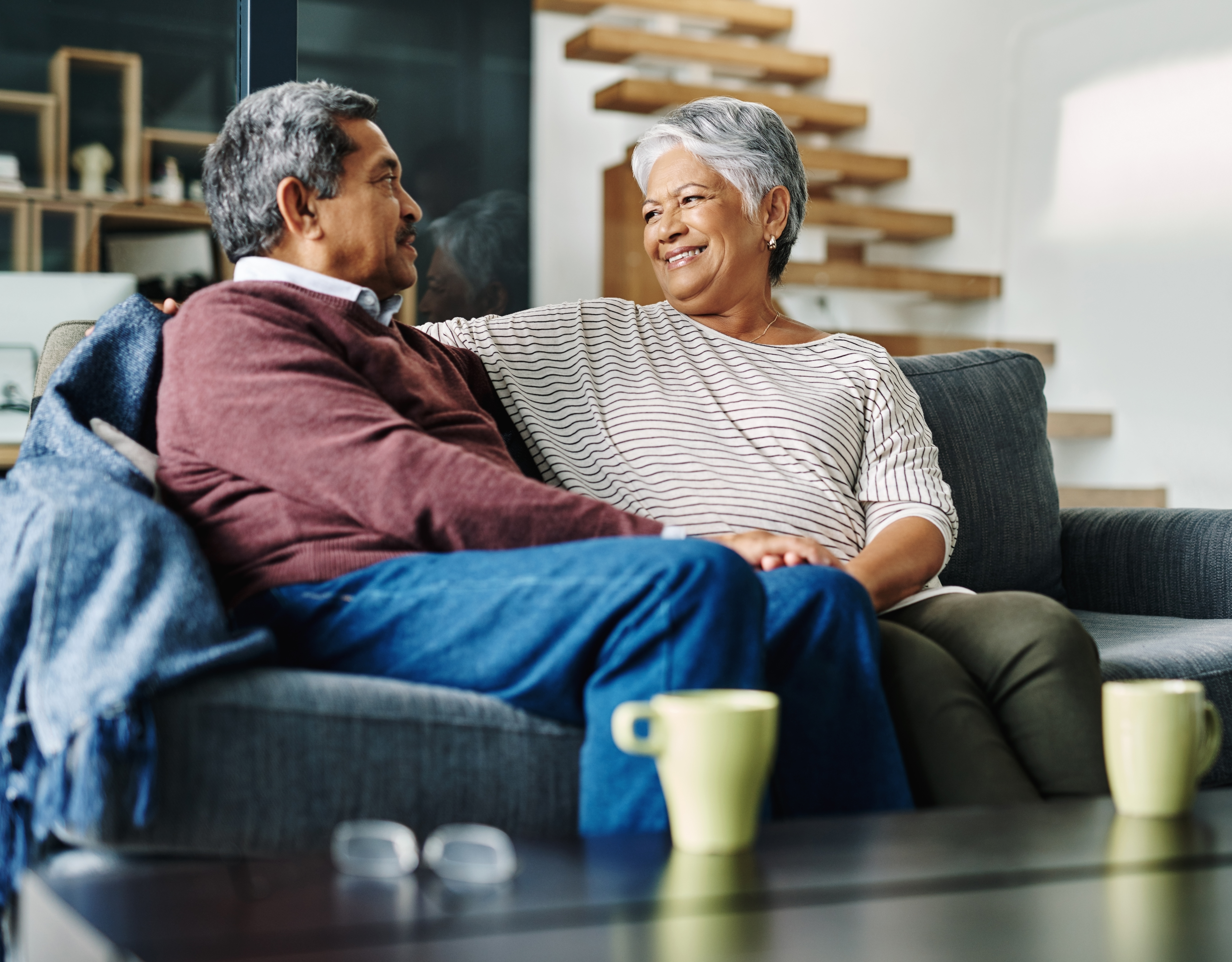 Image of two people smiling toward each other.